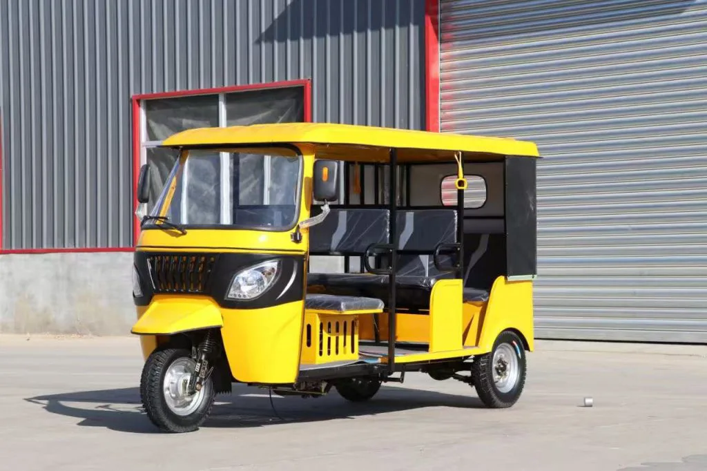 Three-row electric tuk tuk – front three-quarter view at the factory